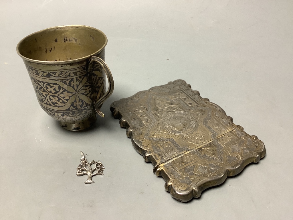 A Victorian engraved silver card case, George Unite, Birmingham, 1877, 10.1cm, together with a white metal and niello small cup and small 925 tree charm.